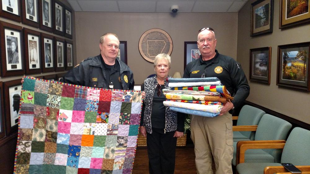 The Chairman of Community Quilts Jo Ann Moore met with Captain Jeff Lewis and Lieutenant Ralph Bird at the Baxter County Sheriff’s Office to provide a new supply of quilts for Sheriff’s Deputies