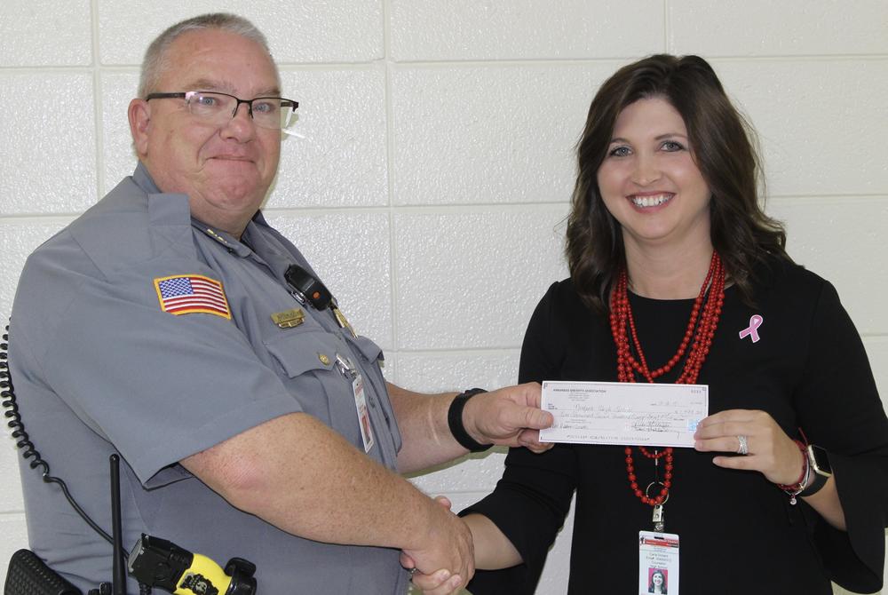 Baxter County Sheriff's Office School Resource Officer Billy Cox applied for the grant and is shown here presenting the check for $1,793.25 to Norfork School Counselor Ms. Carla Dollard.