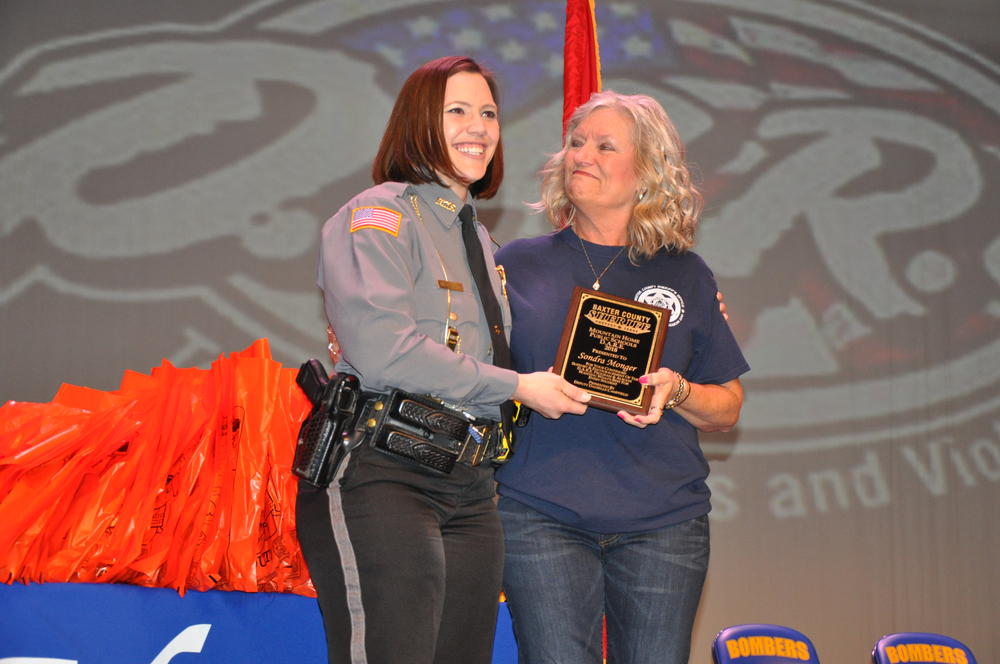 Deputy Danielle Campfield presents Principal Monger a Plaque from the Baxter County Sheriff's Office