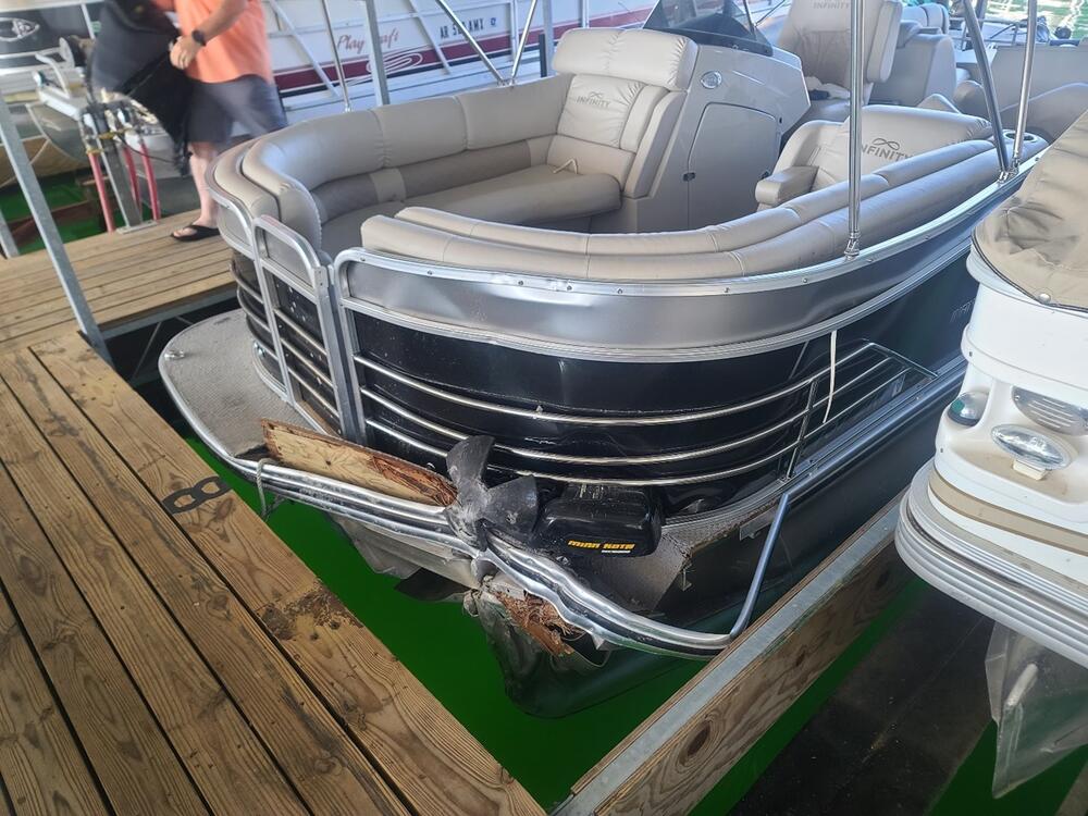A dented in part of a pontoon boat